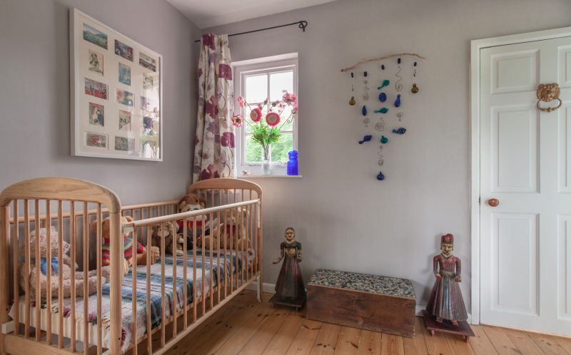 wooden cot for little people staying at The Pink House Lulworth Dorset holiday cottage